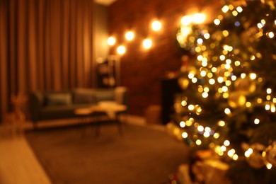 Photo of Blurred view of beautiful Christmas tree with lights in living room