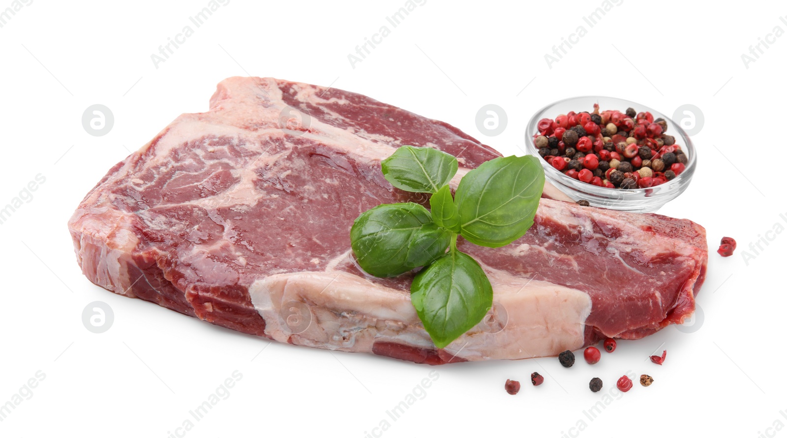 Photo of Piece of fresh beef meat with basil leaves and spices isolated on white