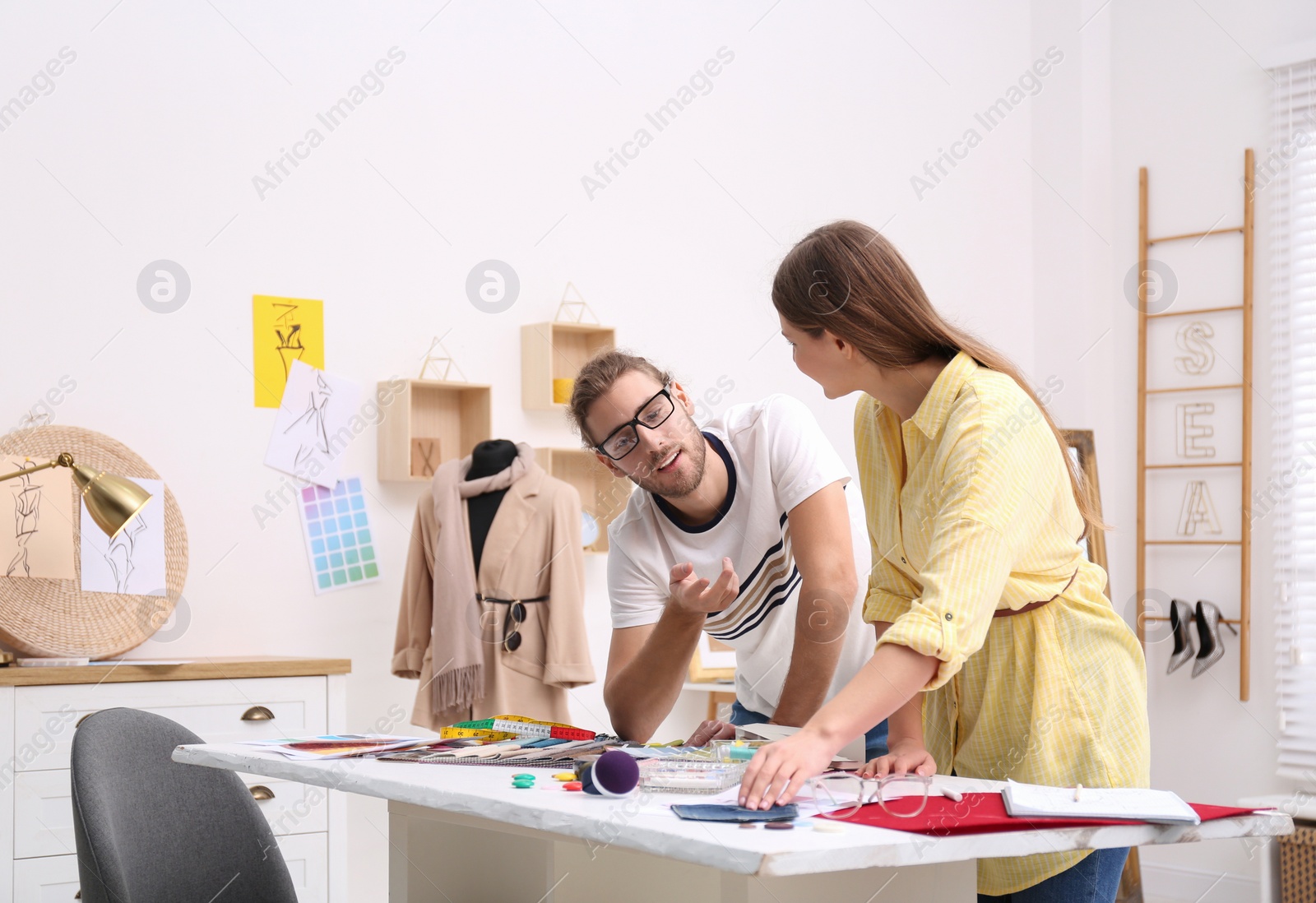 Photo of Fashion designers creating new clothes in studio