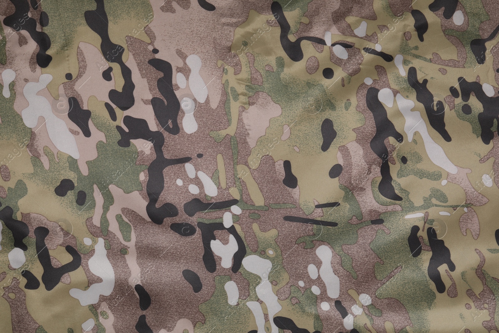 Photo of Texture of camouflage fabric as background, top view