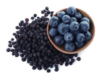 Photo of Sweet sublimated and fresh blueberries on white background, top view