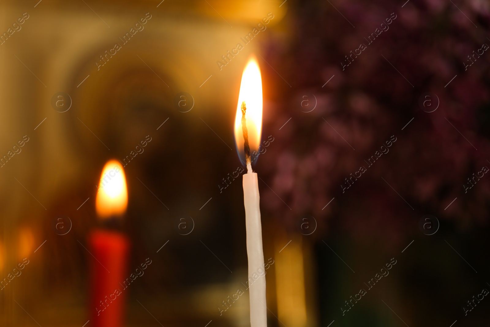 Photo of Closeup view of burning candle in church
