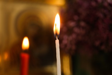 Closeup view of burning candle in church