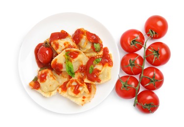 Tasty ravioli and tomatoes on white background, top view