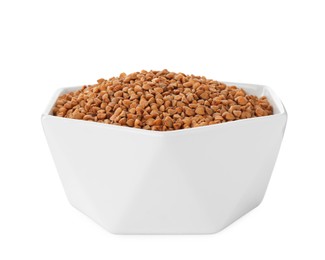 Uncooked buckwheat in bowl isolated on white