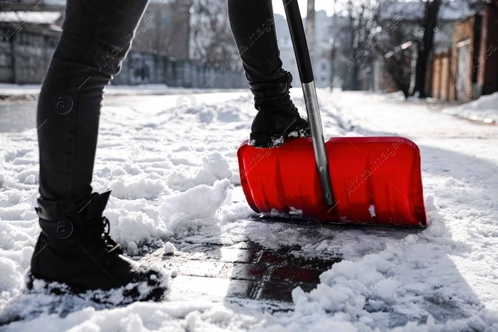 Photo of Person shoveling snow outdoors on winter day, closeup