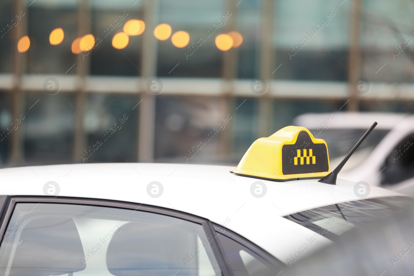 Photo of Taxi cab with yellow sign on city street, closeup