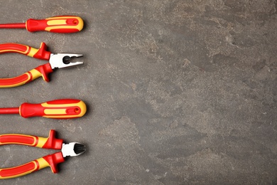 Photo of Flat lay composition with electrician's tools and space for text on gray background