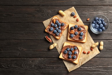 Photo of Toast bread with chocolate spread and blueberry on dark background