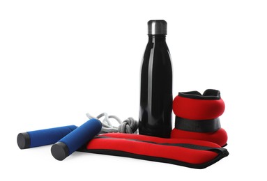 Photo of Stylish weighting agents, skipping rope and sport bottle on white background