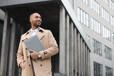 Happy man with folders outdoors, space for text. Lawyer, businessman, accountant or manager