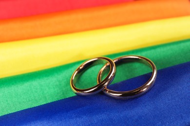 Photo of Wedding rings on rainbow LGBT flag, closeup