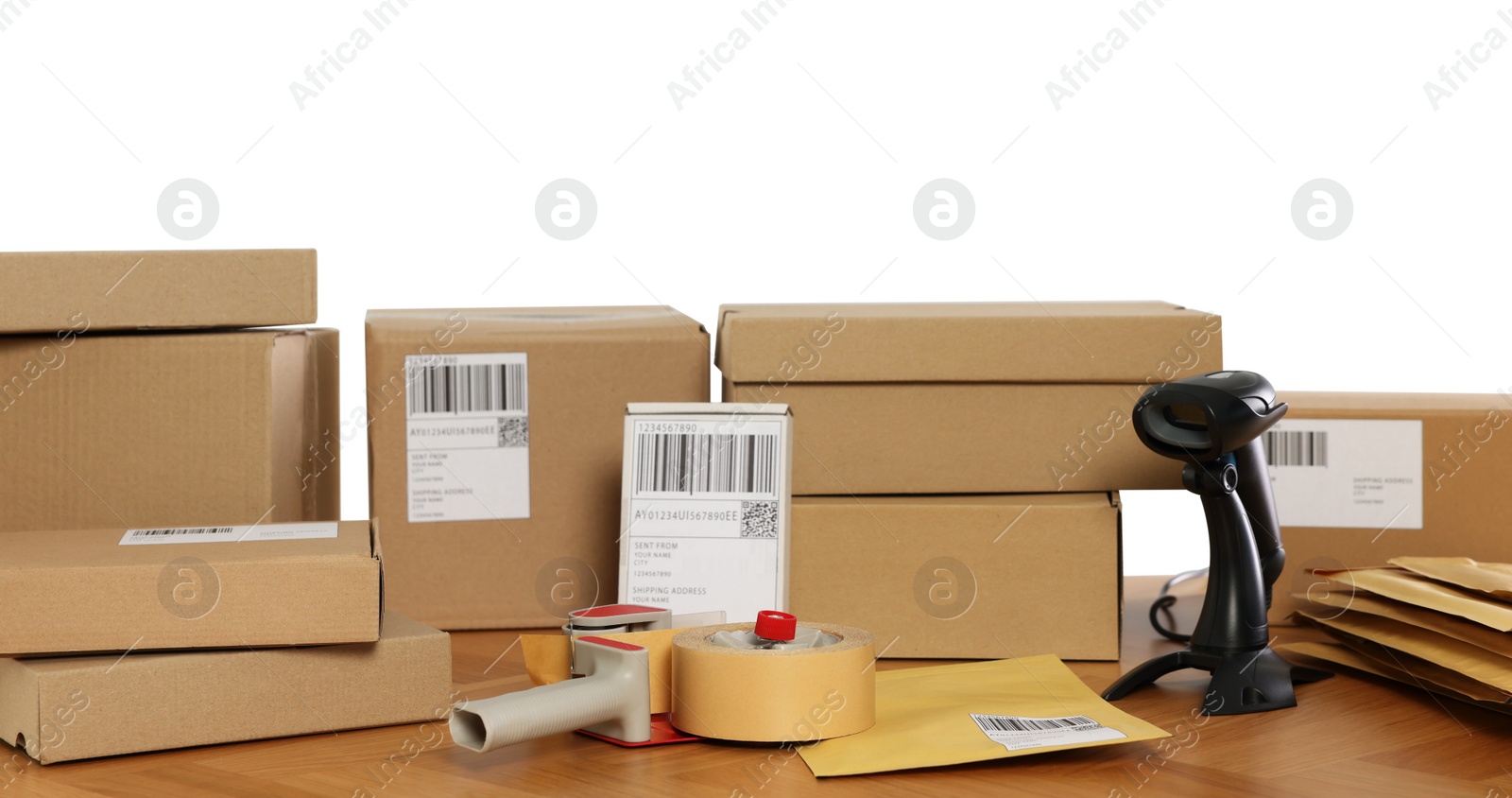 Photo of Parcels, barcode scanner and adhesive tape on wooden table against white background. Online store