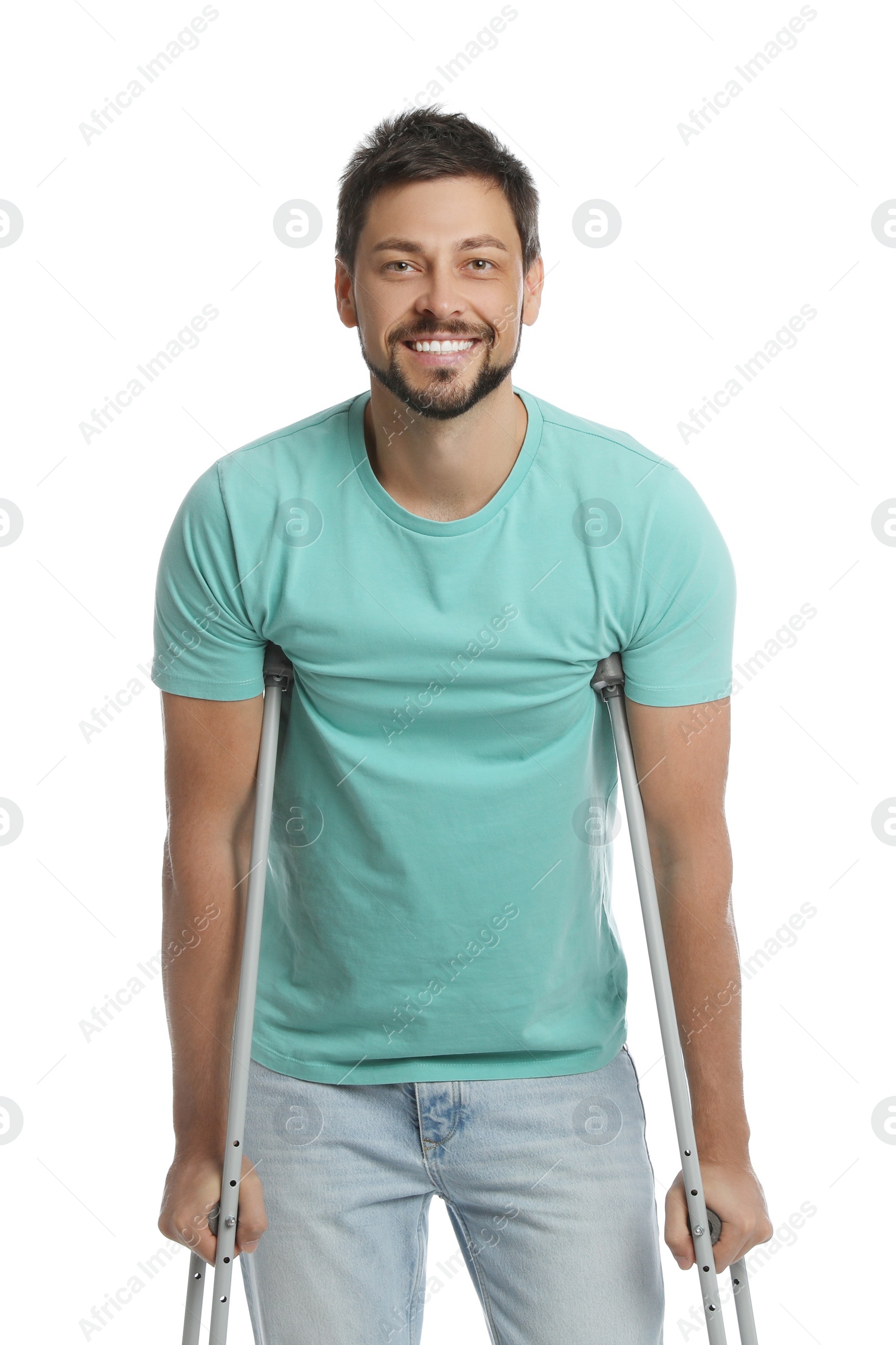 Photo of Portrait of happy man with crutches on white background