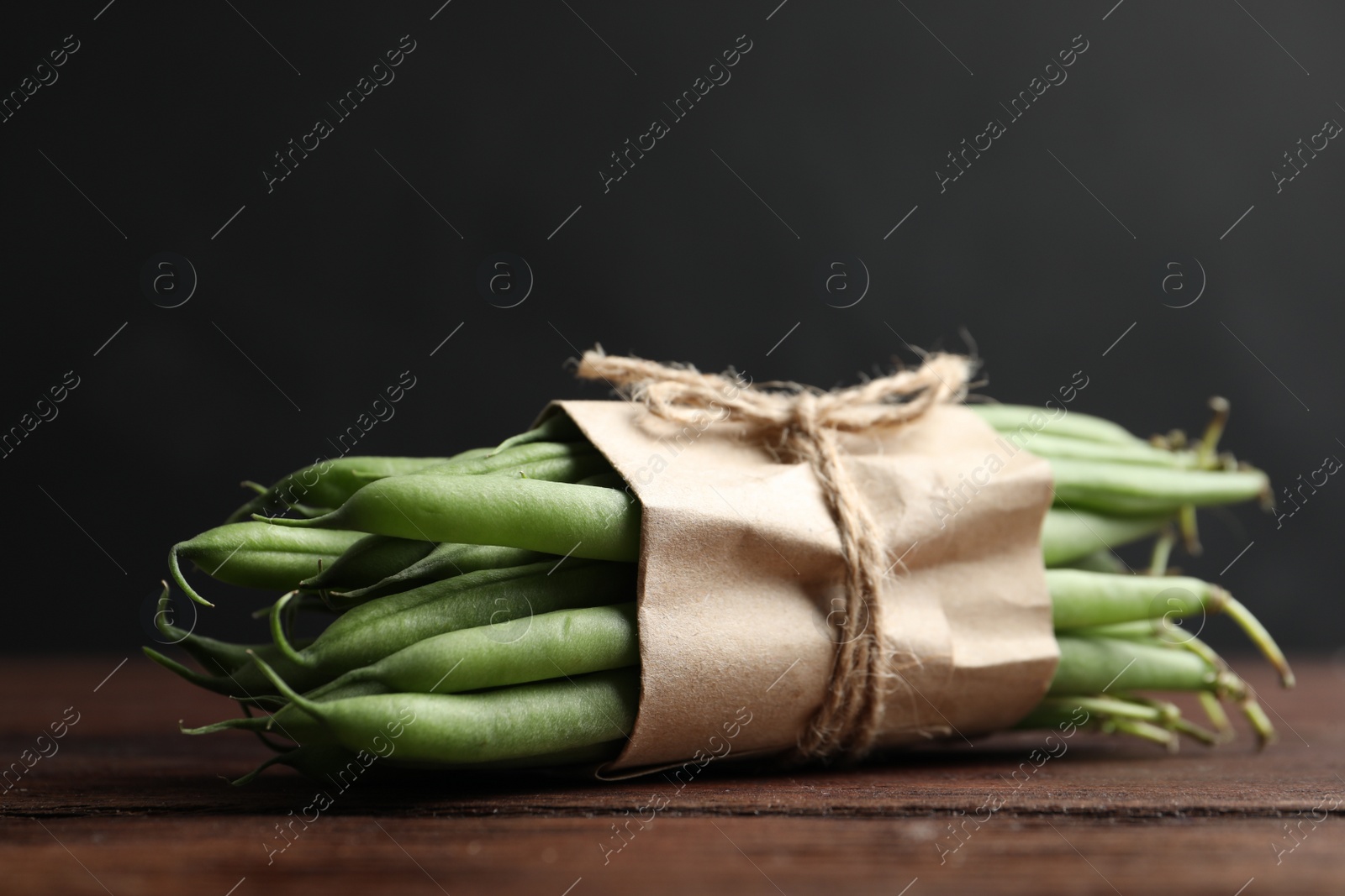 Photo of Fresh green beans on wooden table, closeup