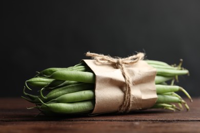 Photo of Fresh green beans on wooden table, closeup