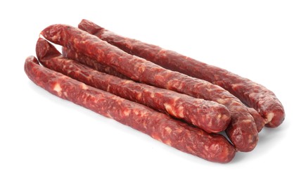 Photo of Thin dry smoked sausages isolated on white