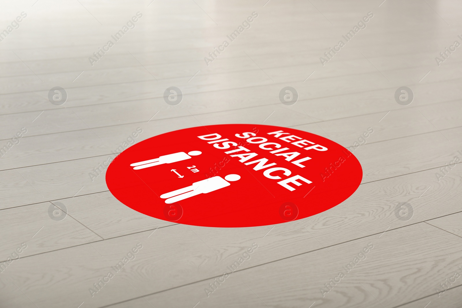 Image of Sign KEEP SOCIAL DISTANCE on floor indoors. Coronavirus pandemic