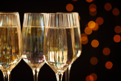 Glasses of champagne against blurred lights, closeup