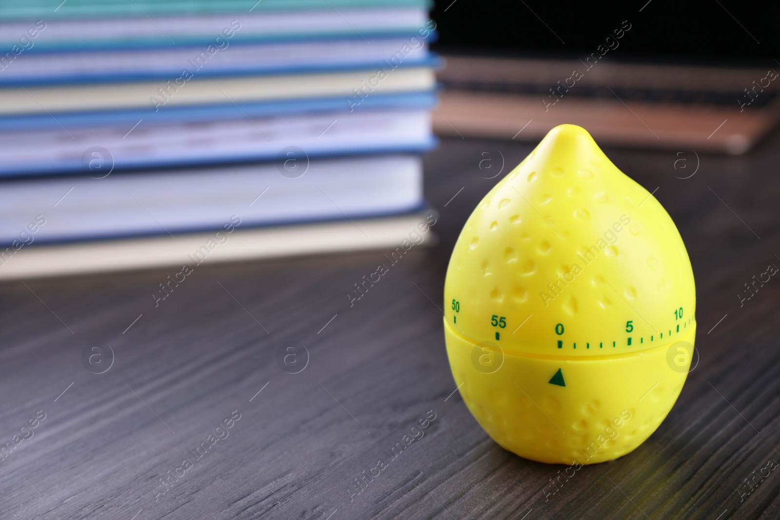 Photo of Kitchen timer in shape of lemon on wooden table, closeup. Space for text