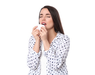 Photo of Young woman with tissue sneezing on white background. Runny nose