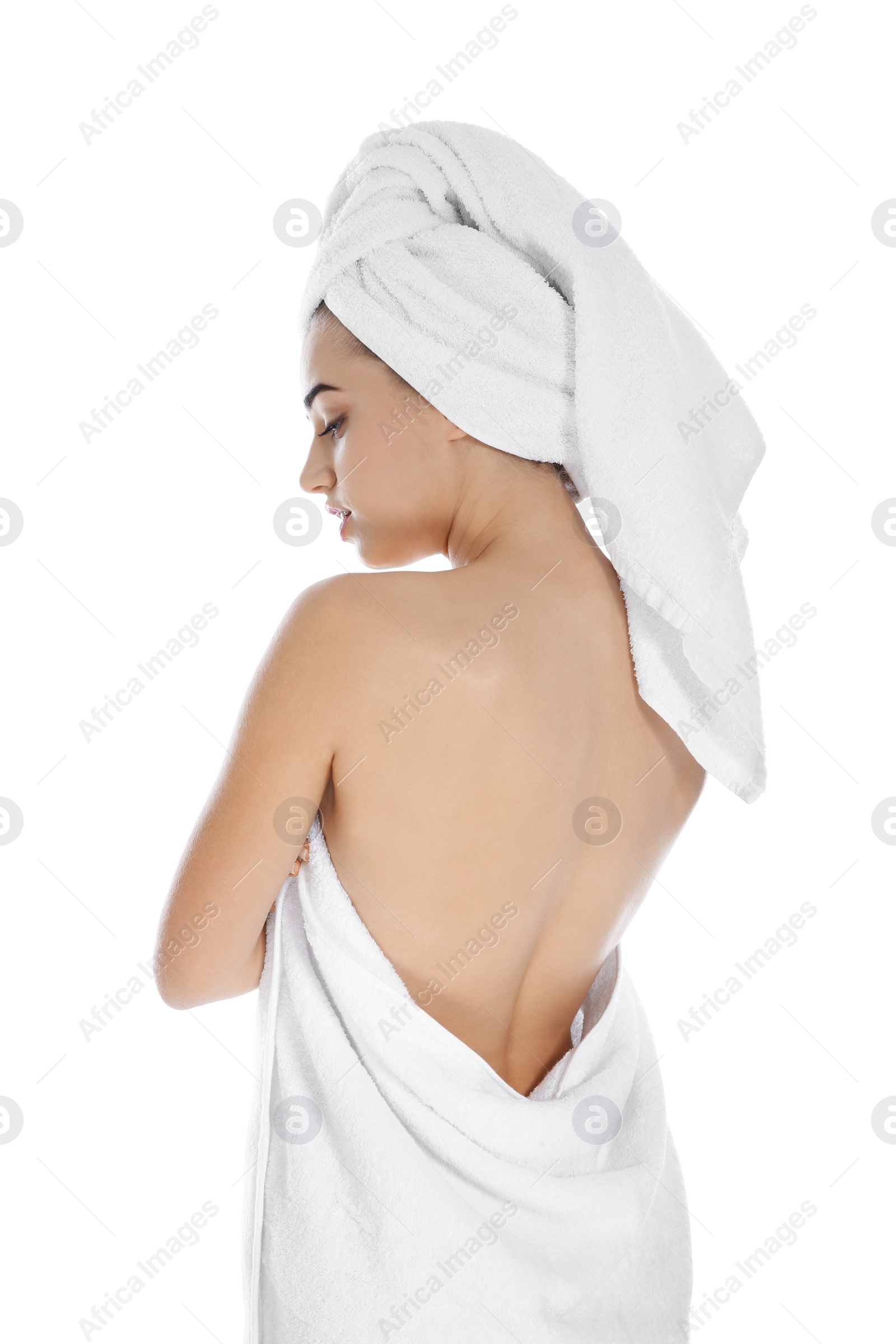 Photo of Young woman with soft towels on white background