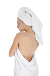 Photo of Young woman with soft towels on white background