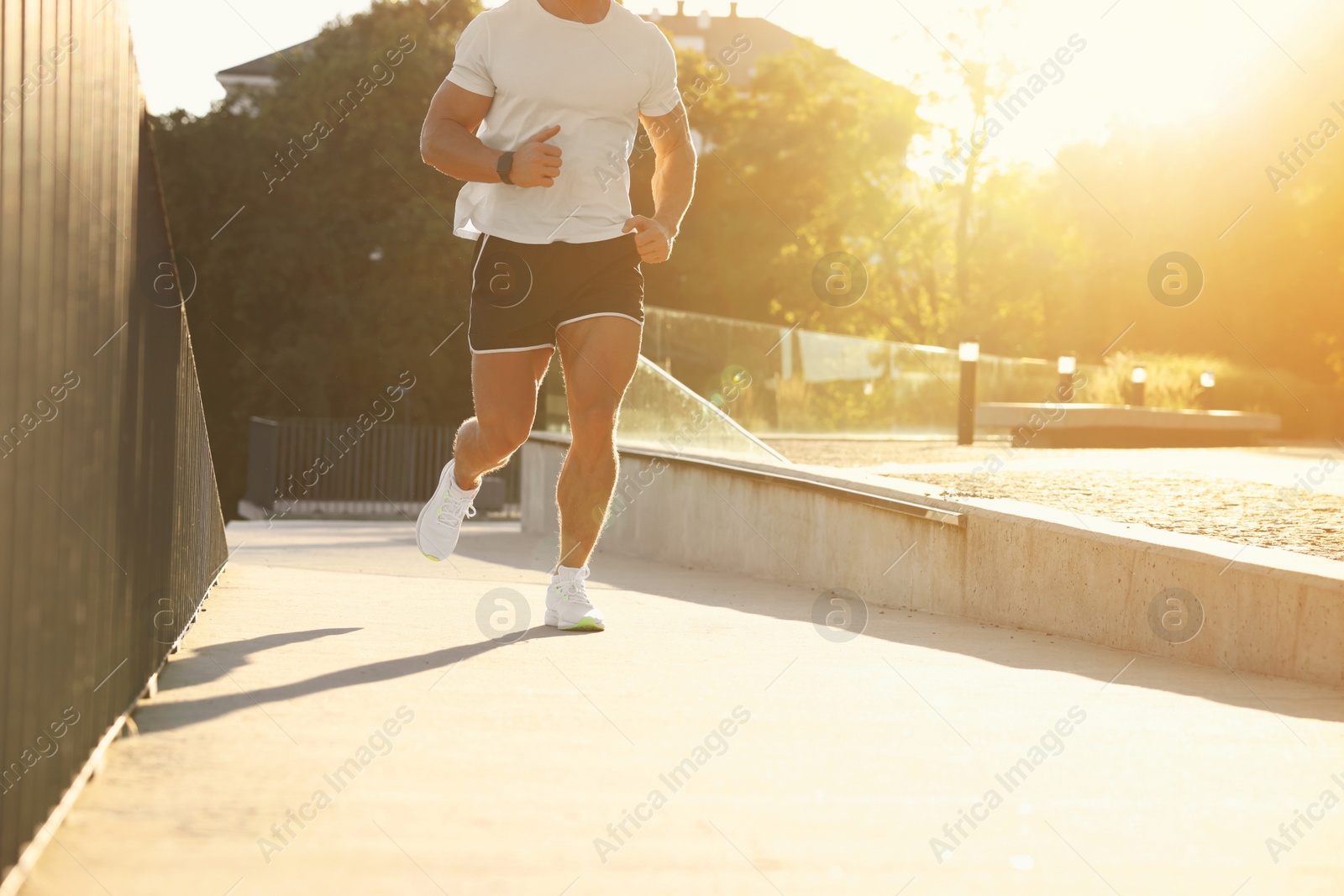 Photo of Man running outdoors on sunny day, closeup. Space for text