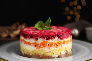 Photo of Herring under fur coat on plate, closeup. Traditional russian salad