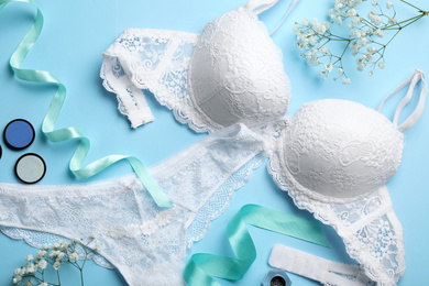 Photo of Flat lay composition with women's underwear on light blue background