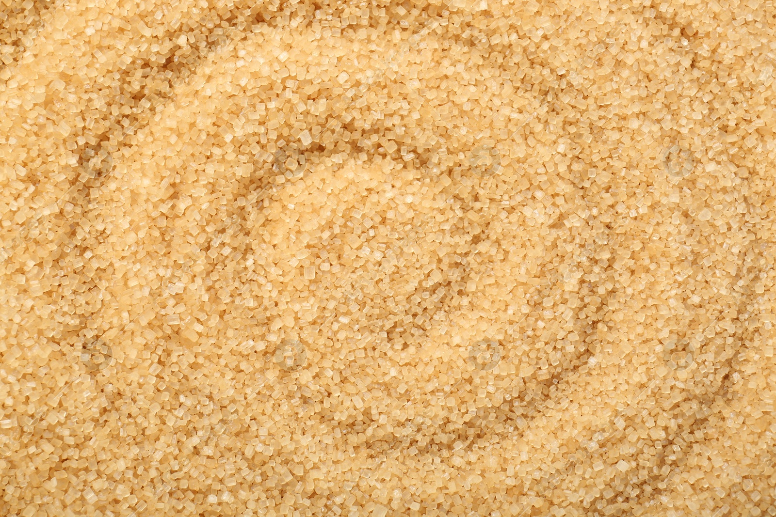 Photo of Granulated brown sugar as background, top view