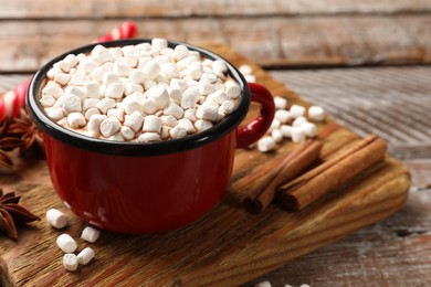 Tasty hot chocolate with marshmallows on wooden table, closeup