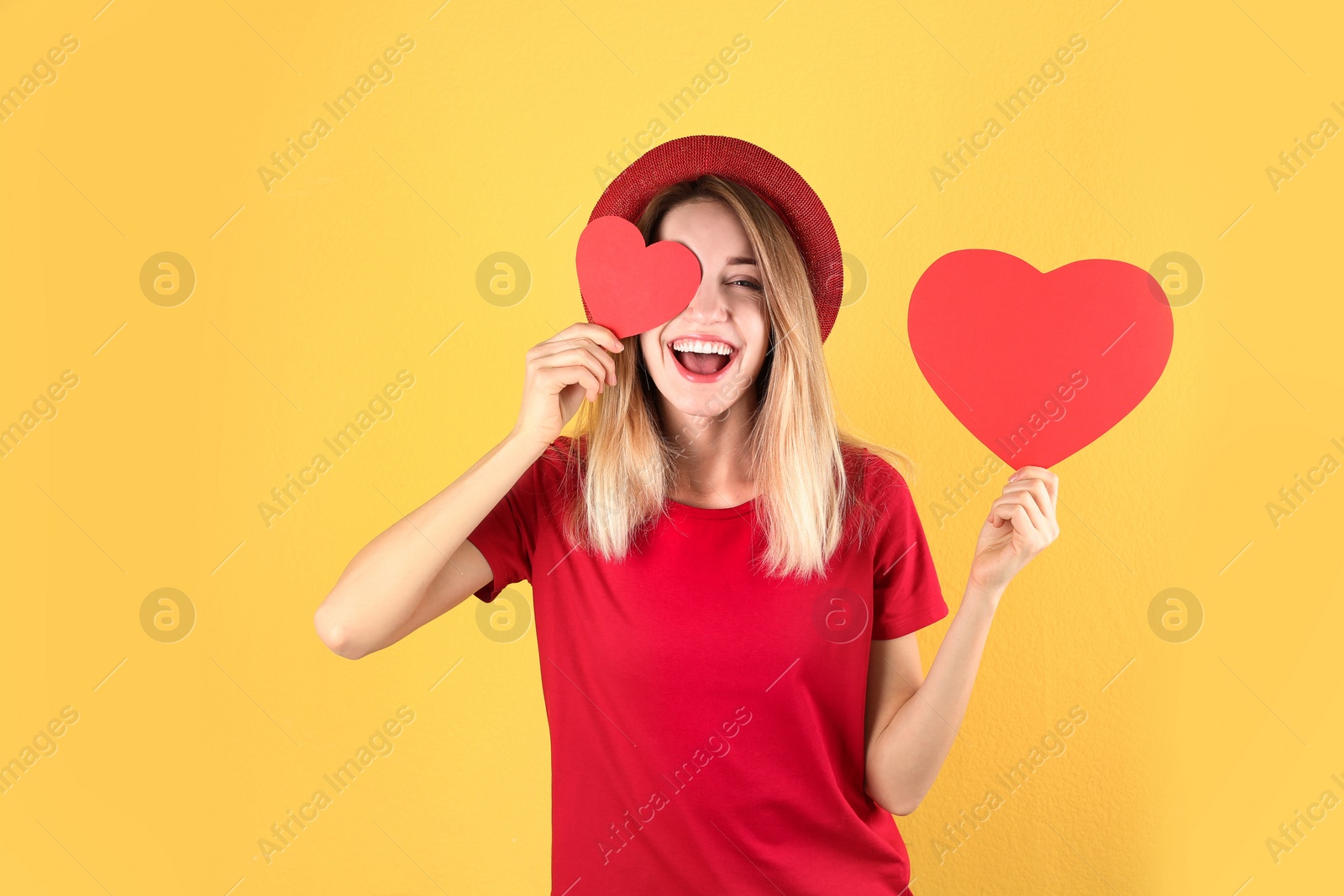 Photo of Portrait of young woman with paper hearts on color background