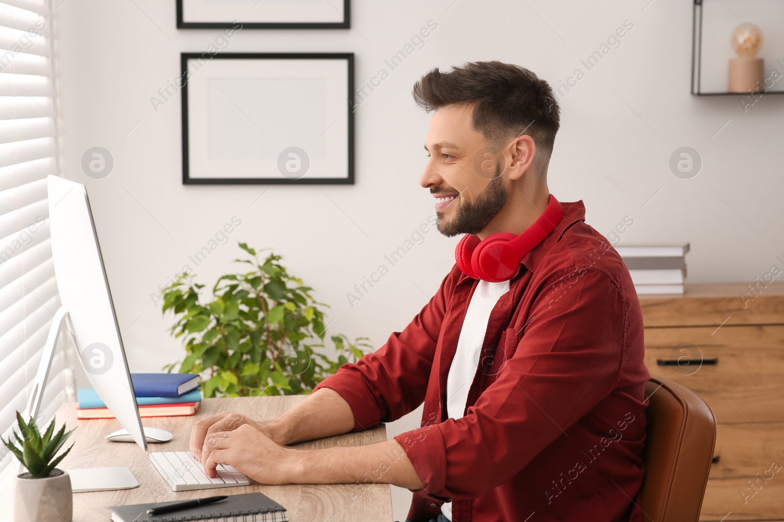 Photo of Man studying on computer at home. Online translation course