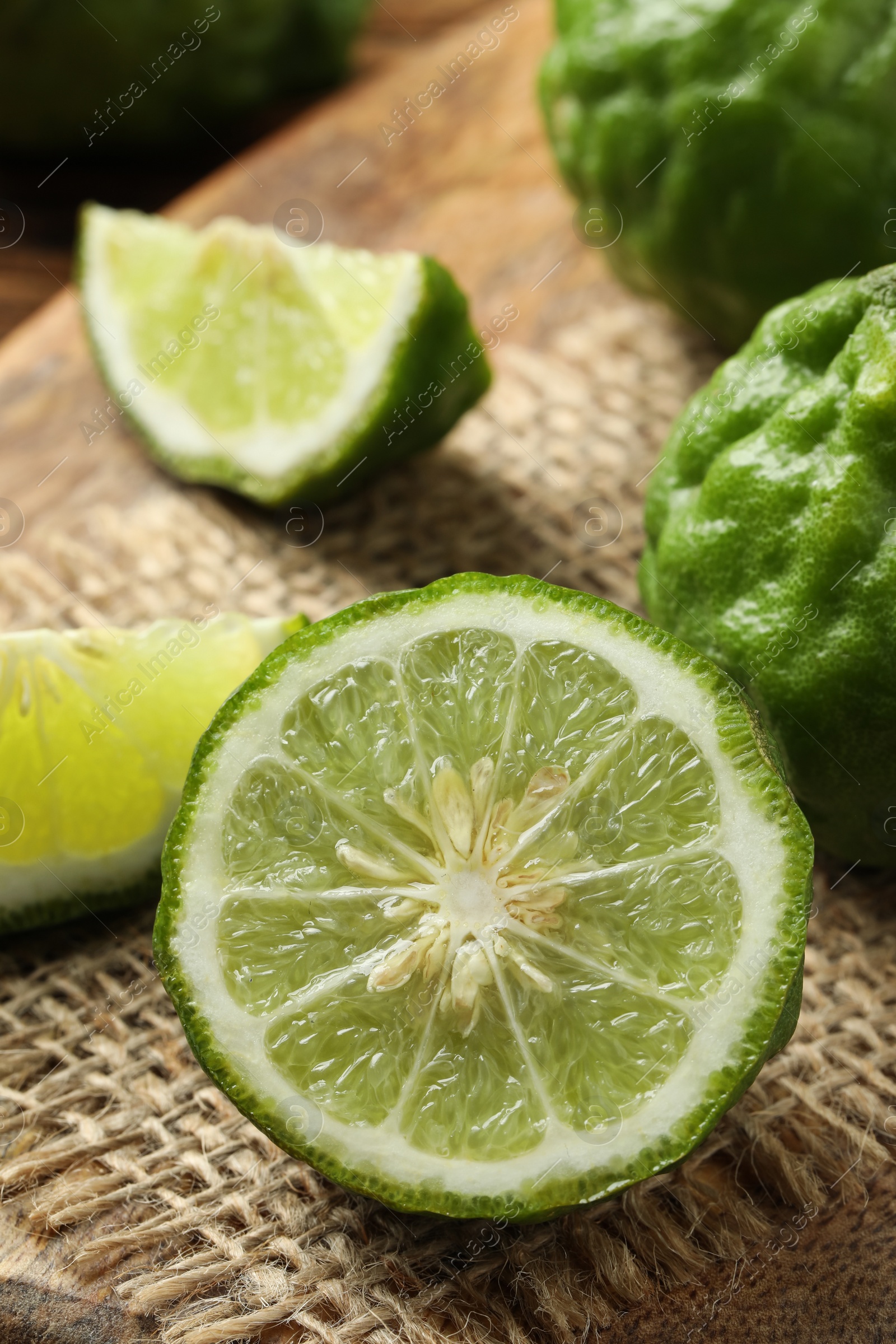 Photo of Fresh ripe bergamot fruits on wooden board, closeup