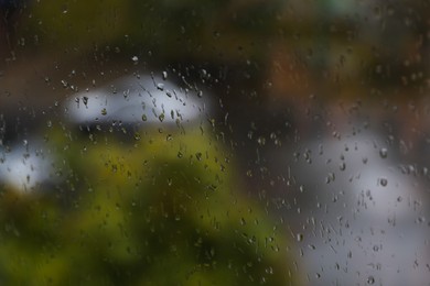 Window glass with water drops, closeup. Rainy weather