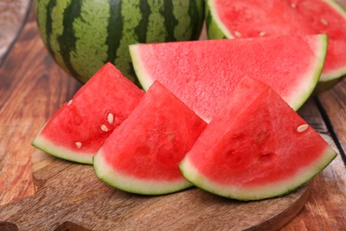 Pieces of juicy ripe watermelons on wooden table, closeup