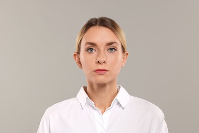 Portrait of beautiful woman on light grey background