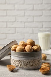 Photo of Delicious nut shaped cookies with boiled condensed milk on light grey table