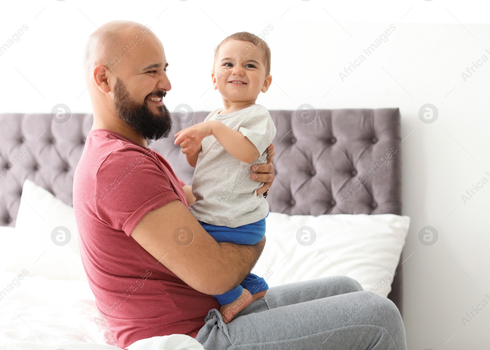 Photo of Dad and his little son spending time together at home