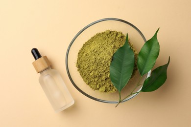 Henna powder, bottle of liquid and green leaves on beige background, flat lay. Natural hair coloring