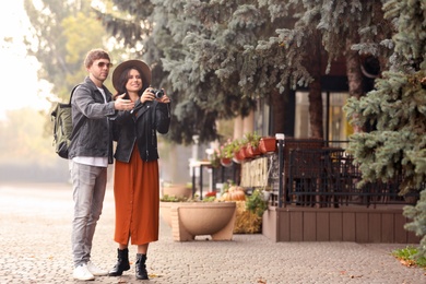Photo of Couple of travelers with camera on city street
