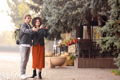 Couple of travelers with camera on city street