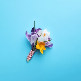 Beautiful crocus bouquet on turquoise background, top view