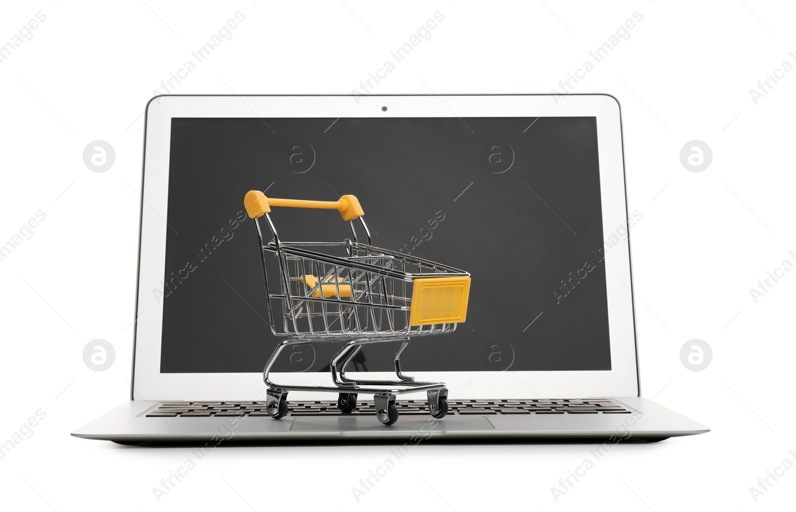 Photo of Internet shopping. Laptop with small cart isolated on white