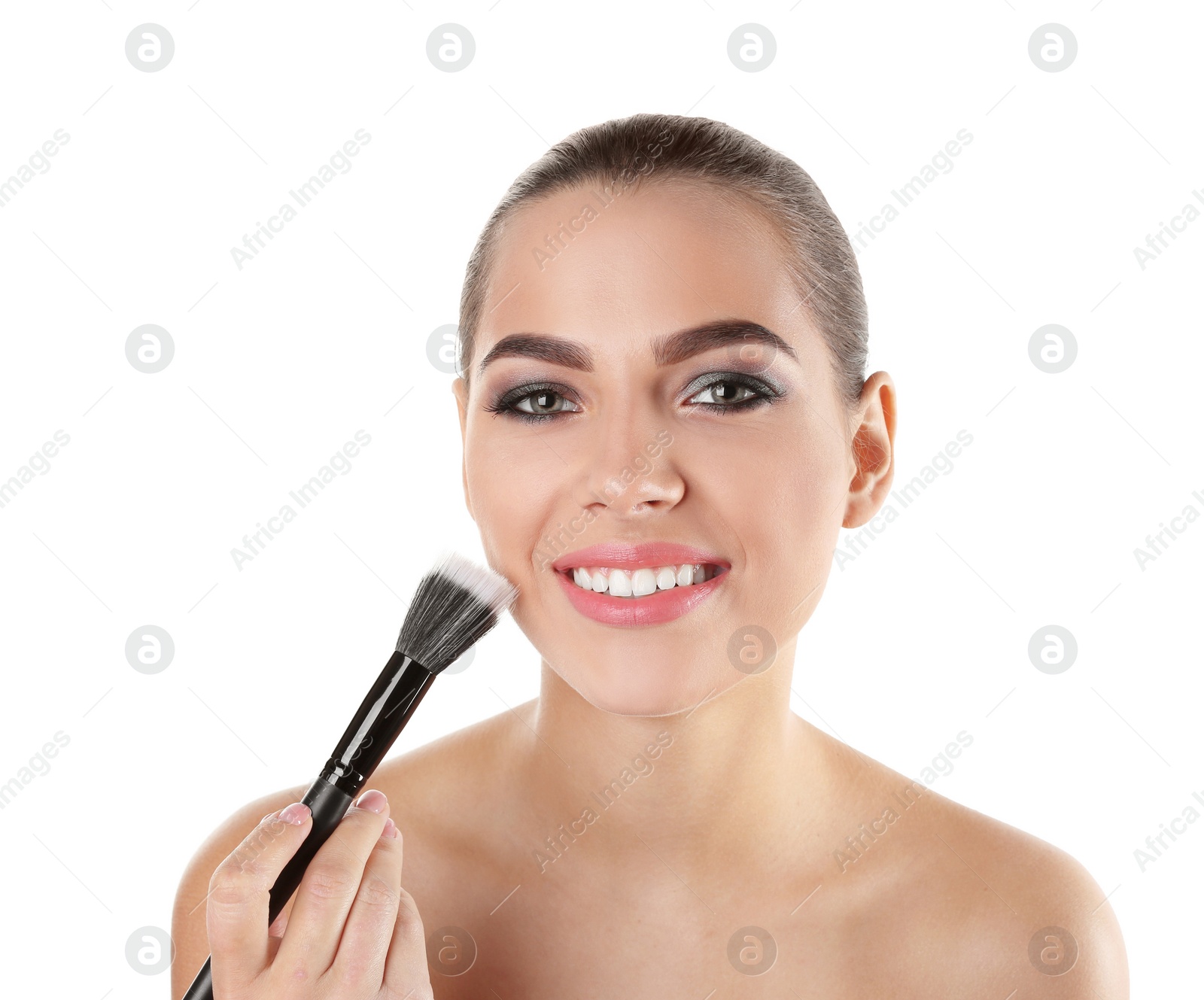 Photo of Portrait of beautiful woman applying face powder with makeup brush on white background