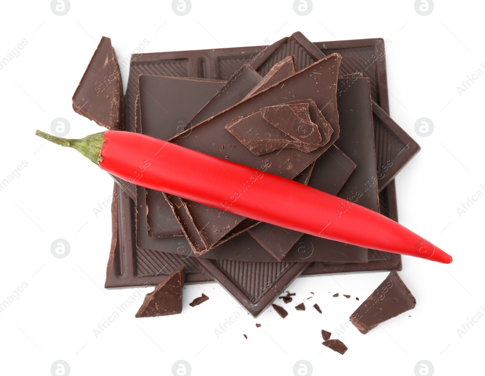 Photo of Red hot chili pepper and pieces of dark chocolate isolated on white, top view