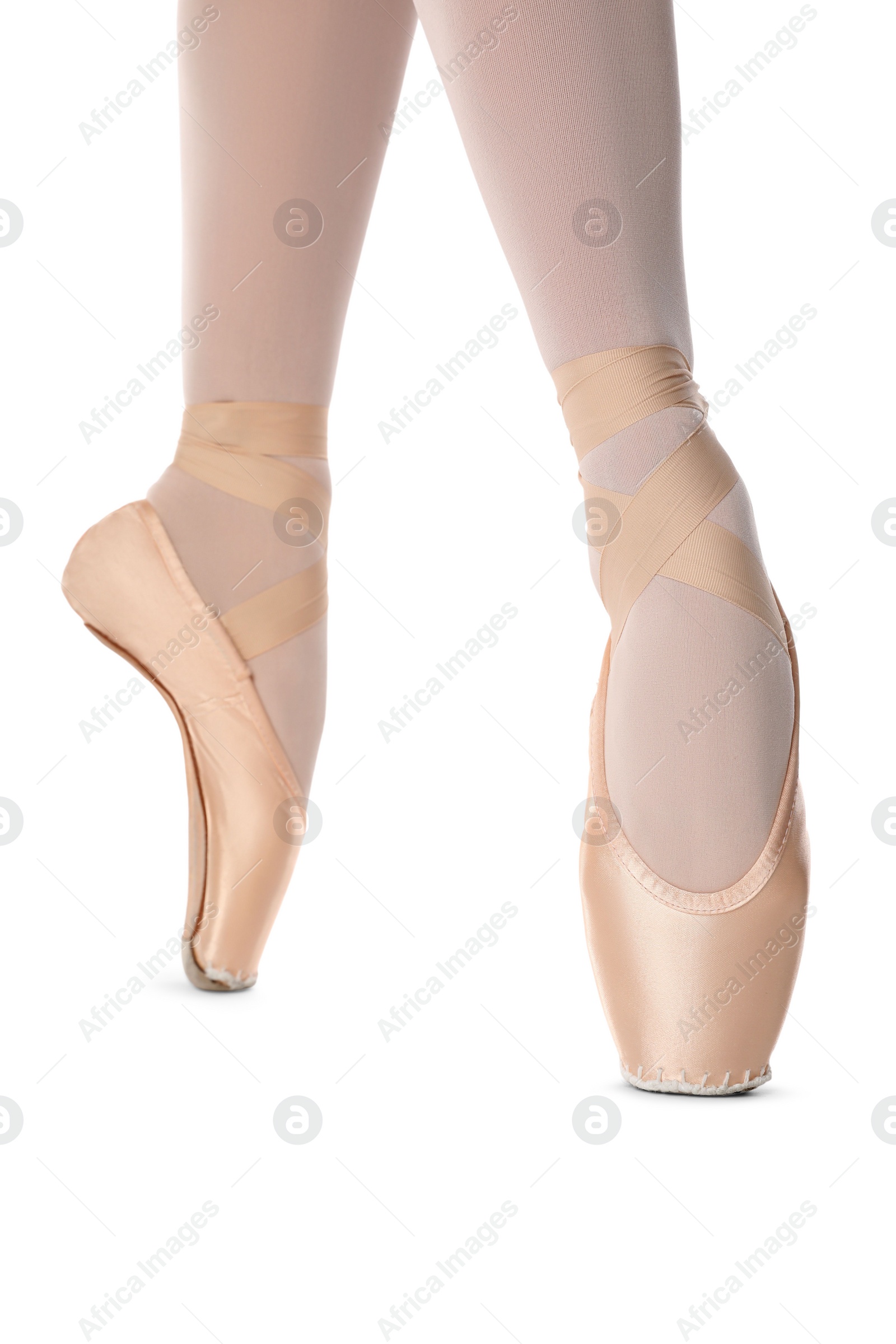 Photo of Ballerina in pointe shoe dancing on white background, closeup