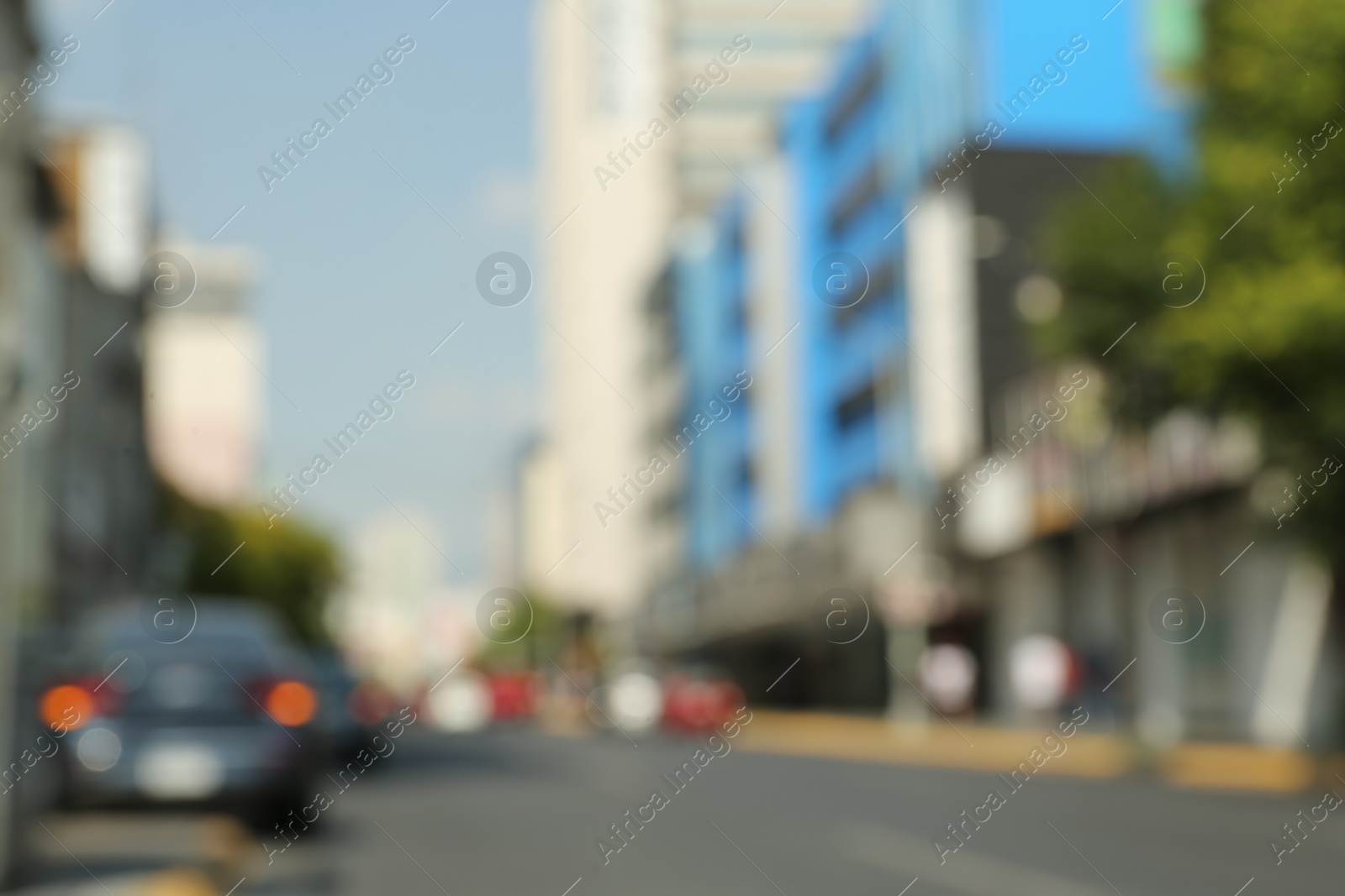 Photo of Blurred view of city street with modern buildings