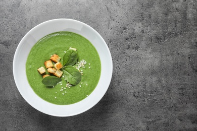 Photo of Fresh vegetable detox soup made of spinach in dish on table, top view with space for text